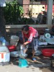 lady selling live frogs for cooking